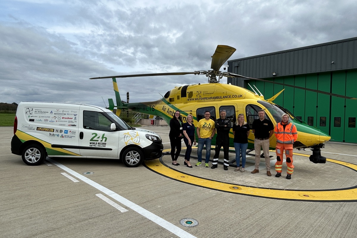Mike Land with the 24hr van pull vehicle parked on the helipad next to the WAA helicopter
