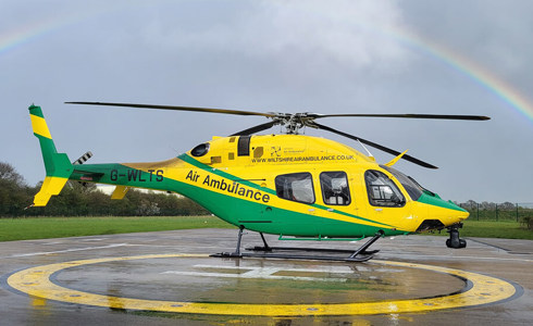 WAA helicopter on the charity's helipad under a rainbow